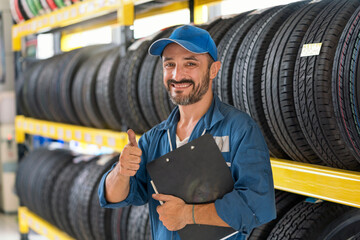 Car repairs. Auto services and Small business concepts. A car mechanic showing his thumb up.