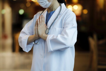 Doctor praying to God with faith and hope