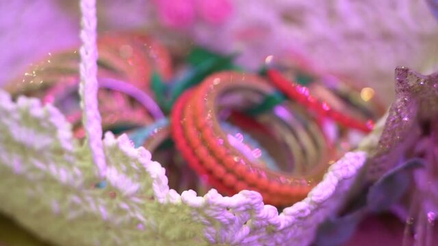 Close up shot of Orange colour jewellery bangles used at Indian wedding reception. Decorative designer bride&rsquo;s bangles. 