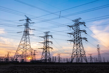 In the evening, the silhouette of high voltage towers
