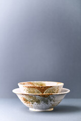 Traditional ceramic bowls on paper background. Copy space. 