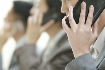 Business people talking on smartphone in office