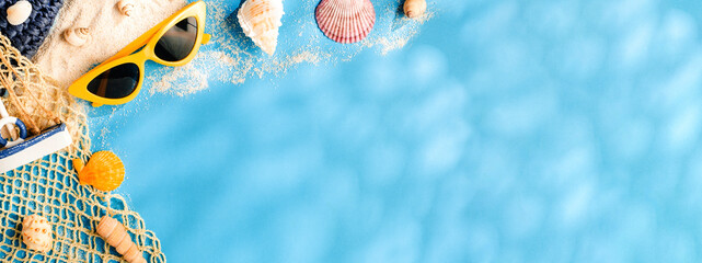 Tropical blue summer sand beach sea with  accessories objects,sunglasses,straw hat and seashell on...