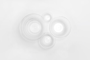 Transparent plastic bowls of different sizes isolated on white background. High-resolution photo.