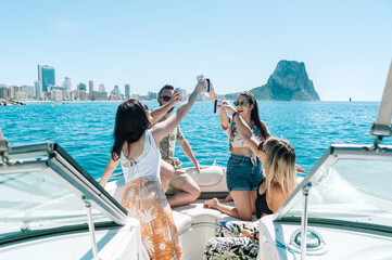 Friends toasting drinks in boat party