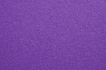 The surface of violet cardboard. Paper texture with cellulose fibers. Bright purple tinted...