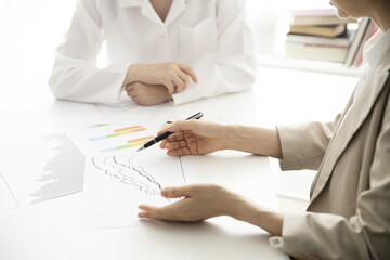 Businesswomen discussing with charts and graphs. Business concept
