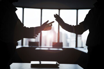 Silhouette business people arguing in meeting room