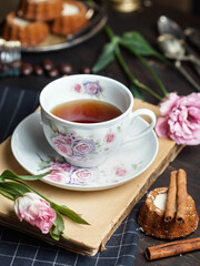 cup of tea with cookies and flowers