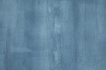 The background is made of cement plastered wall with divorces from the brush when applying paint. Grey, gray blue, blue with a gradient blackout transition. Texture for design and inscription