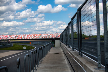 Obraz premium racing sports cars at the circuit race along the track on a sunny day 