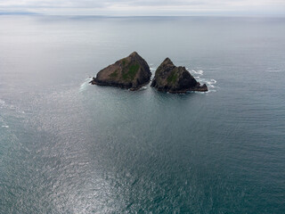 Holywell bay islands also know as gull or carters rocks in cornwall england uk aerial drone