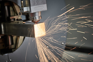 Laser cutting of metal pipe with sparks on tube laser machine