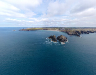Fototapeta na wymiar Holywell bay islands also know as gull or carters rocks in cornwall england uk aerial drone
