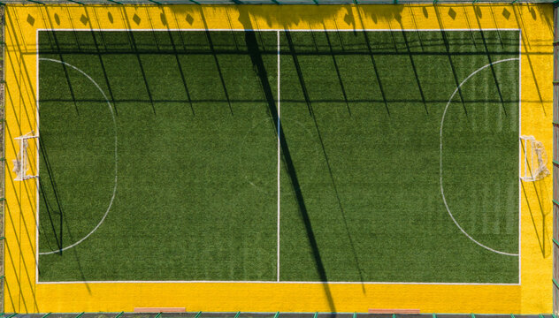 Lawn soccer field with white lines and the gate. Aerial view of an empty soccer field. Photo from drone.