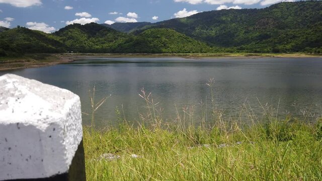 Reveal Shot From Behind A Pillar Of The Huai Prue Reservoir From Tar Road River Bank In Nayok, Thailand.