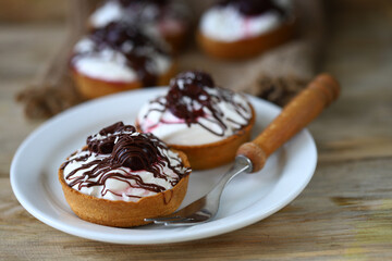 Delicious tartlets with mascarpone cheese, cherries and chocolate. Healthy dessert.