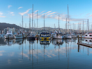 Fototapeta na wymiar Boats in calm harbor with reflections