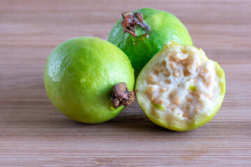 Fresh guava fruits over cutting board