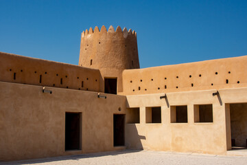 Interior corner of Al Zubarah Fort with circular tower and two levels of solider rooms