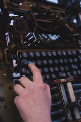 Woman's hand pressing buttons on the typewriter