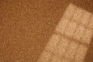 Fototapeta premium Shadow Line From the Window on Cork Board. Cork background with blinds light and shadows