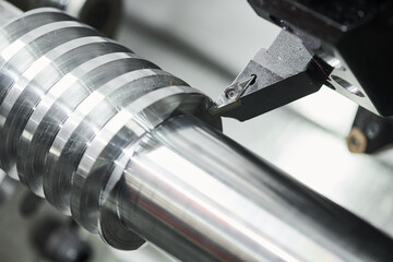 Fototapeta turning operation on cnc machine. metal cut work industry. Precision manufacturing and machining obraz