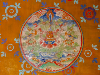 Beautiful intricate mural painting representing the emblem of the three great Bodhisattvas with lotus, sword and two headed birds, in Ogyen Choling palace, Bumthang, Bhutan