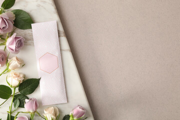Scented sachet and roses on grey background, top view. Space for text