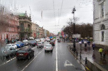 Raindrops on the glass. Blurred urban landscape through the window in the rain, rainy weather.