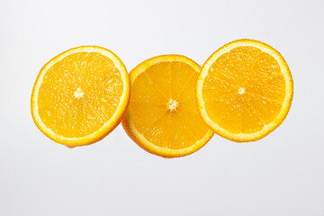 Orange slices on a white background. Ripe juicy oranges. Healthy fruit.