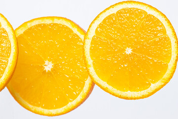Orange slices on a white background. Ripe juicy oranges. Healthy fruit.