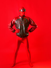A funny super hero in a red leotard and protective glasses