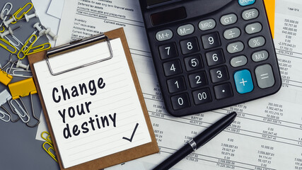 The words Change your destiny written on a white notebook. Work and study concept