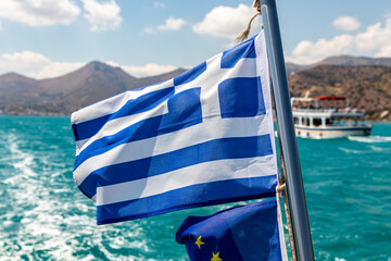 Greek waving flag on a ship off the Greek coast - obrazy, fototapety, plakaty