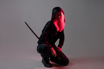 Techno cyber punk style, futuristic ninja, young woman with pink hair