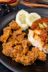 delicious pork belly rice or samcan goreng with rice combined with baby squid and petai, It's characteristic food from North Sumatra - Medan.