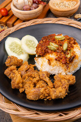 delicious pork belly rice or samcan goreng with rice combined with baby squid and petai, It's characteristic food from North Sumatra - Medan.