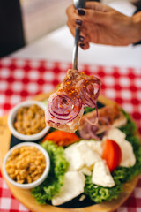 Pihtije i Duvan cvarci - traditional Balkan food. Dish in restarurant.