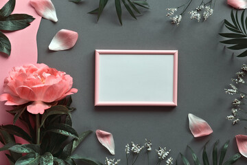 Greeting card mockup, copy space. Peony flower, petals, palm leaves. Single flower and white frame...
