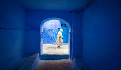 Zelfklevend Fotobehang man walking in a street in Chefchaouen, Morocco © Fernando
