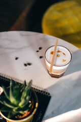 Fototapeta na wymiar Caffee espresso in glass on marble table in cafeteria