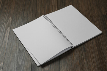 Blank paper brochure on wooden table. Mockup for design