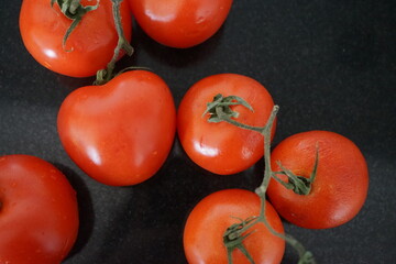 birds eye view of tomatoes on a black counter top