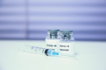 Coronavirus COVID-19 Vaccine Vials and Syringe. COVID-19 vaccine close up