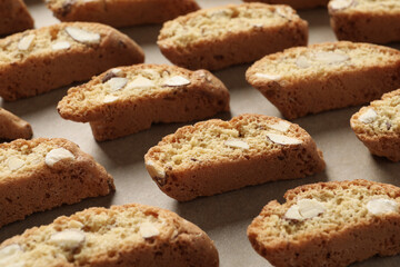 Traditional Italian almond biscuits (Cantucci) on parchment paper, closeup