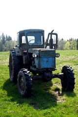 Old blue russian agricultural tractors in the field. Agricultural machinery in the farm. Special Agricultural Equipment