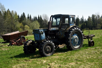 Old blue russian agricultural tractors in the field. Agricultural machinery in the farm. Special...