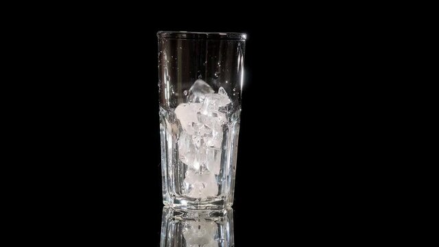 ice fnd limon falls asleep in a glass on a black background