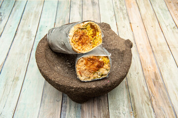 Male burrito with chipotle sauce on natural stone mortar - obrazy, fototapety, plakaty
